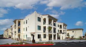 A white building with a red stripe in front.