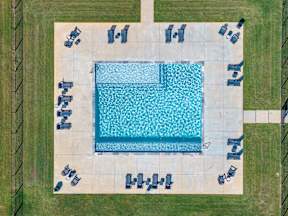 An aerial view of a swimming pool surrounded by lounge chairs.