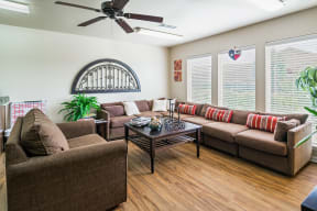 a living room with couches and chairs and a ceiling fan in Granbury