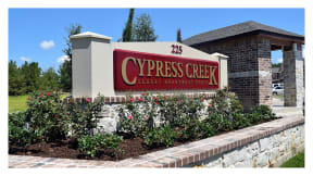 a photo of the cypress creek sign in front of the building