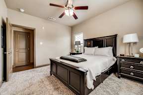 Primary bedroom with ceiling fan at Timber Creek Apartments in Sulphur Springs, TX