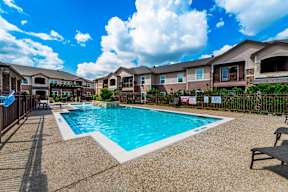 Swimming pool and apartment homes at Timber Creek Apartments in Sulphur Springs, TX