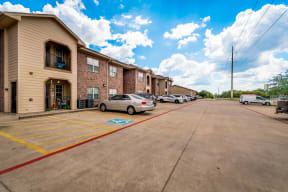 a parking lot at the whispering winds apartments in pearland, tx