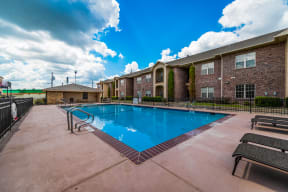 a swimming pool with a blue sky in the background at The Corners Apartments in Sulpher Springs