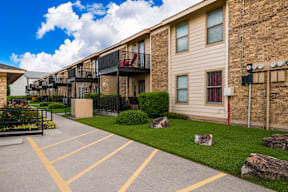A sunny day at the apartment complex with a clear blue sky.