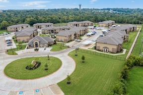 A large roundabout is in the center of a housing development.