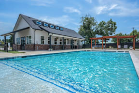 A swimming pool at Flat Creek Apartments s with a black fence.