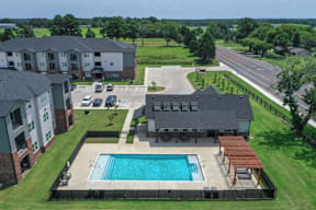 A swimming pool at Flat Creek Apartments with Cabanas