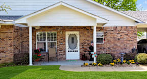 A house with a white door and a small porch.