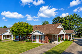 A house with a red brick exterior and a white roof.