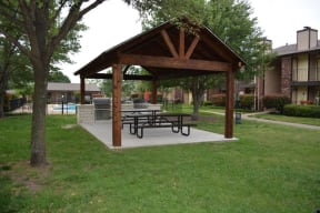 a pavilion with a picnic table in a park