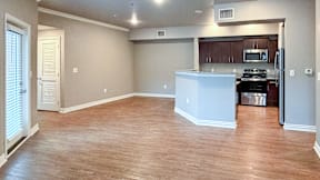 A kitchen area with a white refrigerator and a microwave.