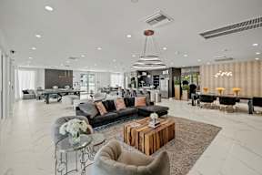 A modern living room with a grey sofa and a coffee table.