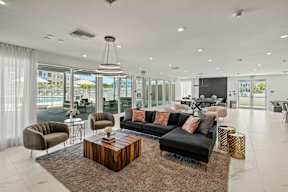 A modern living room with a large window overlooking the ocean.