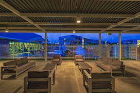 A row of benches are lined up on a patio.