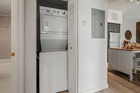 A modern kitchen with a white oven and a refrigerator.