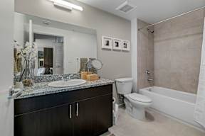 A bathroom with a sink, toilet, and bathtub.