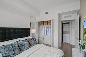 A bedroom with a large bed and a black headboard.