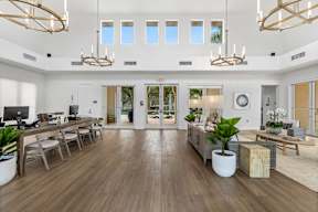 the living room has a large open floorplan with wood floors and white walls