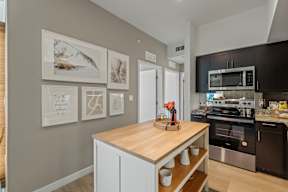 A kitchen with a wooden countertop and stainless steel appliances.