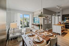 A modern dining room with a table set for a meal.
