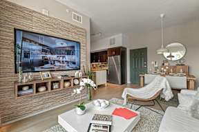 A modern living room with a flat screen TV on the wall.