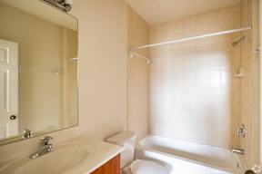 A bathroom with a sink, toilet, and bathtub.