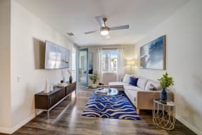 a living room with a couch and a ceiling fan