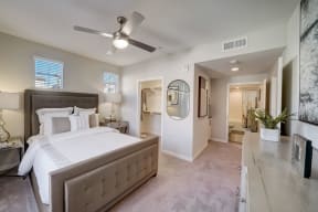 a bedroom with a large bed and a ceiling fan