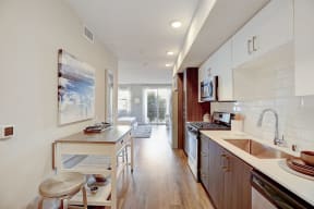 Modern kitchen featuring a sleek countertop, undermount sink, and high-end finishes at Eleven10