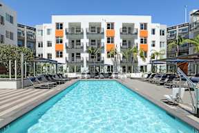 a swimming pool in front of an apartment building