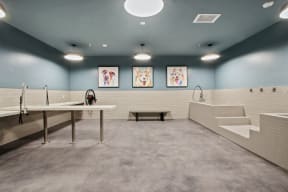 a large bathroom with a sink and a toilet and a urinal and a table