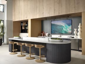 a modern kitchen with a large island and stools