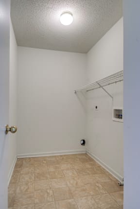 a bedroom with white walls and a white closet