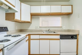 a kitchen with white cabinets and white appliances