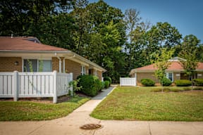 A house with a white picket fence in front of it.