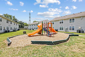 a playground at the enclave at woodbridge apartments in sugar land, tx