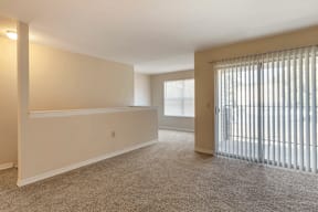 Open Floor Plan with Carpeted Living Room with Sliding Glass Patio Door
