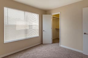 Carpeted Bedroom with Window and Walk in Closet
