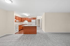 A kitchen with a white fridge and wooden cabinets.