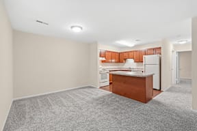 A dining room and kitchen with a countertop and cabinets.