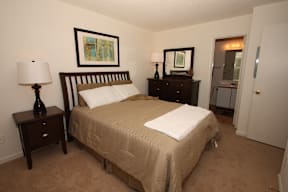 a bedroom with a bed and two night stands