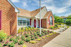 Leasing Office Exterior with Sidewalk and Plants