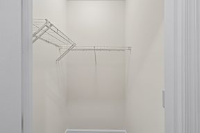 Empty white closet with wire storage racks