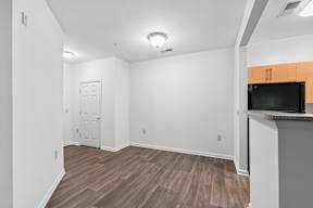 A room with a wooden floor and a black countertop.