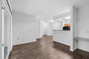 A living room with wooden floors and white walls.