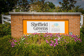 A sign for Sheffield Greens apartments