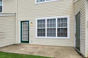 A house with a green door and a white window.