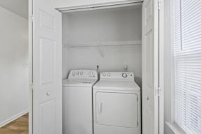 A white laundry room with a washer and dryer.