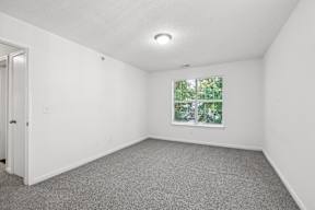 A room with a window and a door.